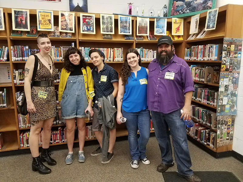 bennu staff standing in front of a row of bookcases at Webb Middle School