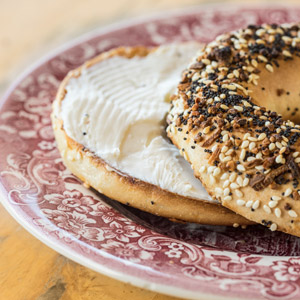 everythign bagel with cream cheese on a plate